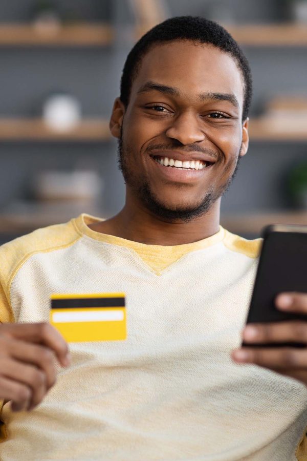 cheerful-african-american-man-with-credit-card-and-NQH72F9.jpg